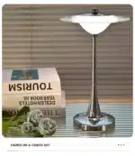 Goldoma rechargeable table lamp with flying saucer shape and warm glow on a bedside table