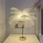 Ostrich feather table lamp glowing warmly on a bedside table in a cozy bedroom