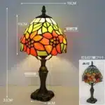 Tiffany table lamp with colorful stained glass shade casting warm glow on nightstand