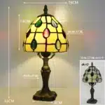 Tiffany table lamp with colorful stained glass shade casting warm glow on nightstand