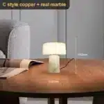 Elegant marble table lamp with soft glow on bedside table in bedroom