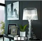 Modern acrylic table lamp glowing softly on a bedside table in a contemporary bedroom