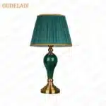 Green ceramic table lamp with European cloth shade in a modern living room setting