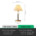 Retro desk lamp with black metal base and pleated fabric shade in warm glow