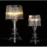 Modern acrylic table lamp glowing softly on a bedside table in a contemporary bedroom