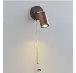 Walnut bedside wall light with adjustable spotlight and zipper switch in a cozy bedroom