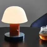 Nordic retro mushroom table lamp with warm LED glow on a bedside table