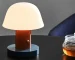 Nordic retro mushroom table lamp with warm LED glow on a bedside table