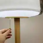 Modern bedside lamp with cream glass shade on a nightstand