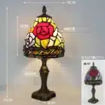 Tiffany table lamp with colorful stained glass shade casting warm glow on nightstand