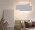 Modern wall sconce with three-layer stacked LED design in a living room