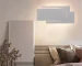 Modern wall sconce with three-layer stacked LED design in a living room