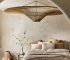 Handwoven bamboo pendant light hanging above a dining table, casting a warm glow